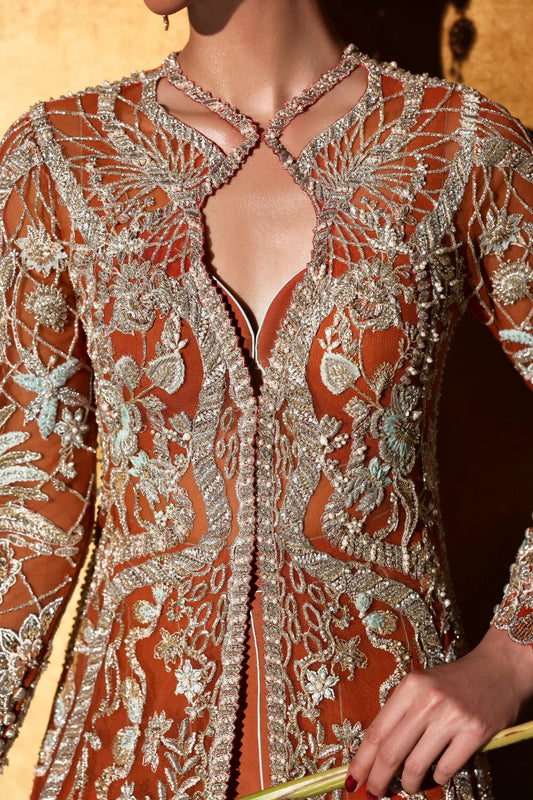 Soraya Veyra luxury formal close-up with intricate embroidery and cutwork on burnt orange net fabric
