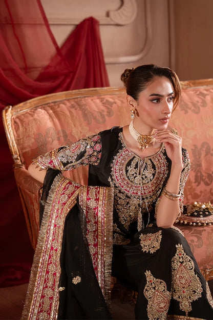 Close-up of black Pakistani designer dress featuring intricate embroidery, handwork and embellished dupatta for wedding wear
