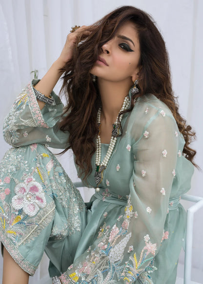 Close-up of luxury hand embroidered organza Pakistani party wear dress with floral embellishments, premium designer outfit for women.

