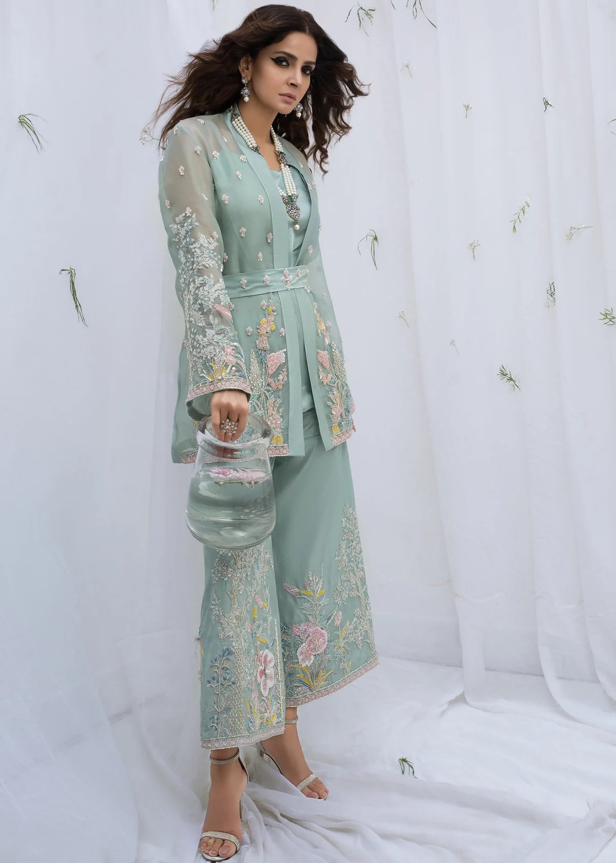 Luxury mint organza Pakistani designer party wear suit with hand embroidery, floral embellishments and matching culottes, elegant formal wear for weddings, Eid and festive occasions.