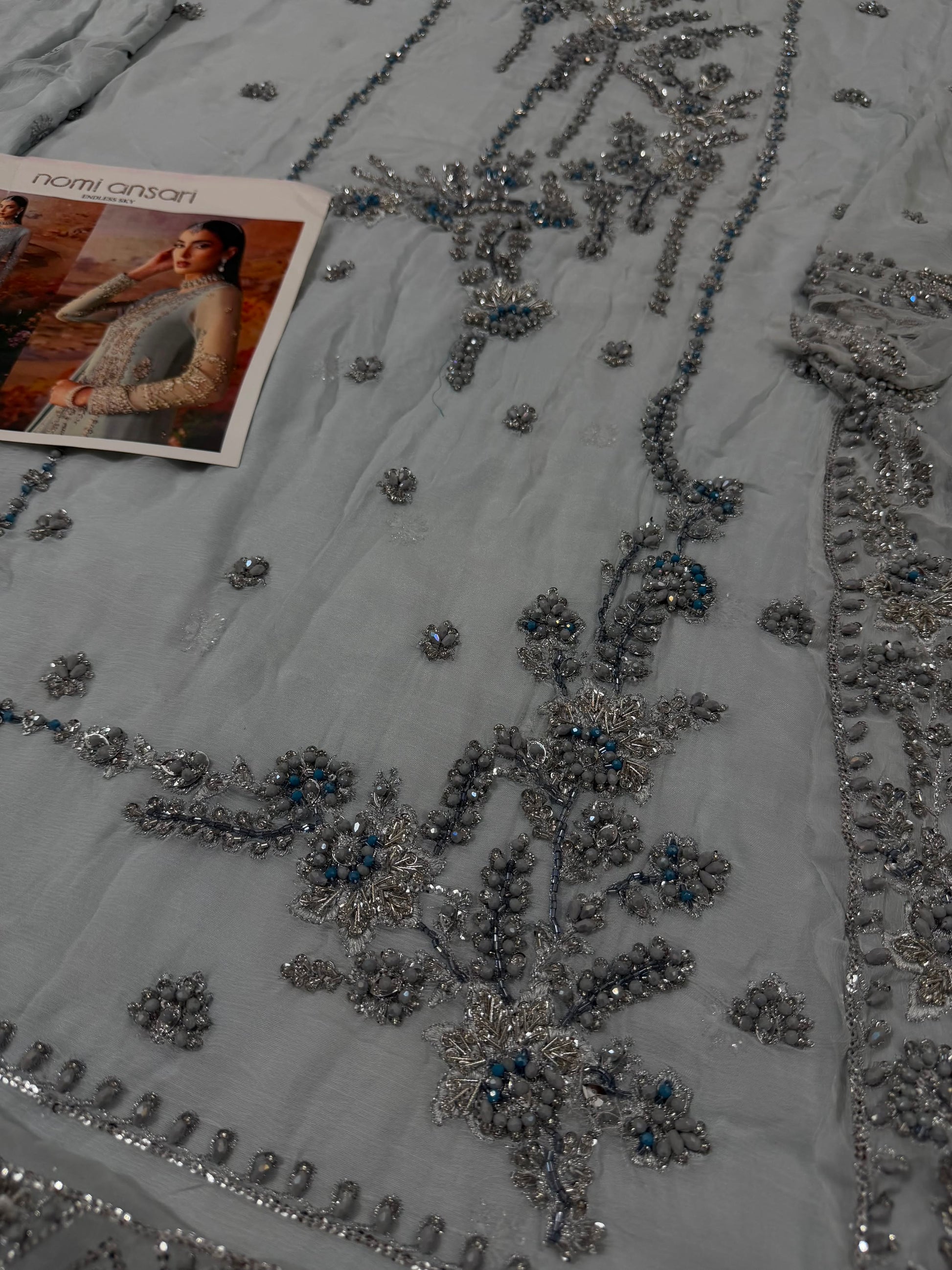 Nomi Ansari inspired luxury chiffon party wear suit photographed in Nimzstudio. Elegant Pakistani designer inspired outfit with silver embellishments.