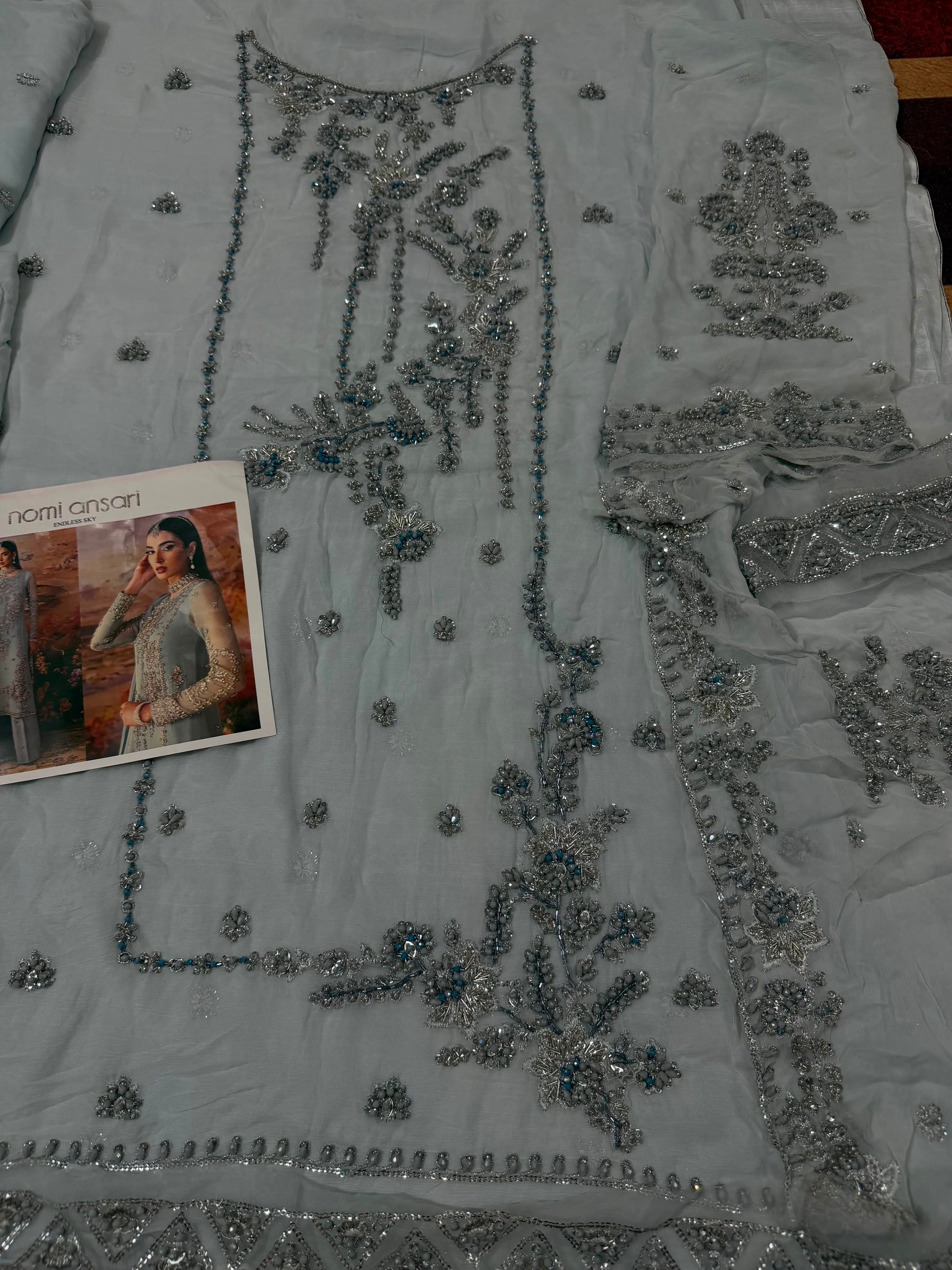 Close-up of the neckline and sleeve embroidery on a Nomi Ansari inspired luxury chiffon Pakistani outfit featuring premium silver embellishments and elegant craftsmanship.