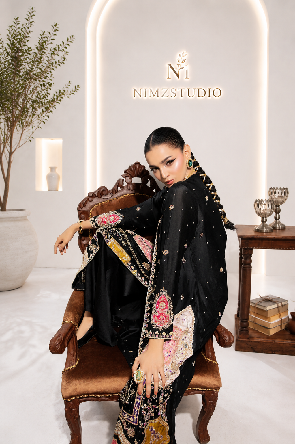Saira Noor inspired black embroidered Pakistani designer 3-piece party wear dress in elegant seated pose, luxury wedding outfit for women | Nimzcollection