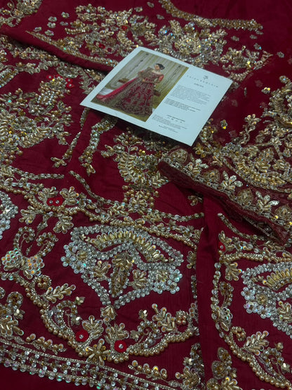 Detailed bridal portrait wearing Faiza Saqlain Arusa luxury Pakistani designer red raw silk wedding maxi.