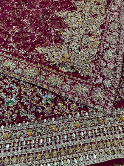 Luxury Haris Shakeel embroidered dupatta pallu with handcrafted mirror work, sequins and detailed floral embroidery on a maroon Pakistani designer inspired wedding sharara suit.