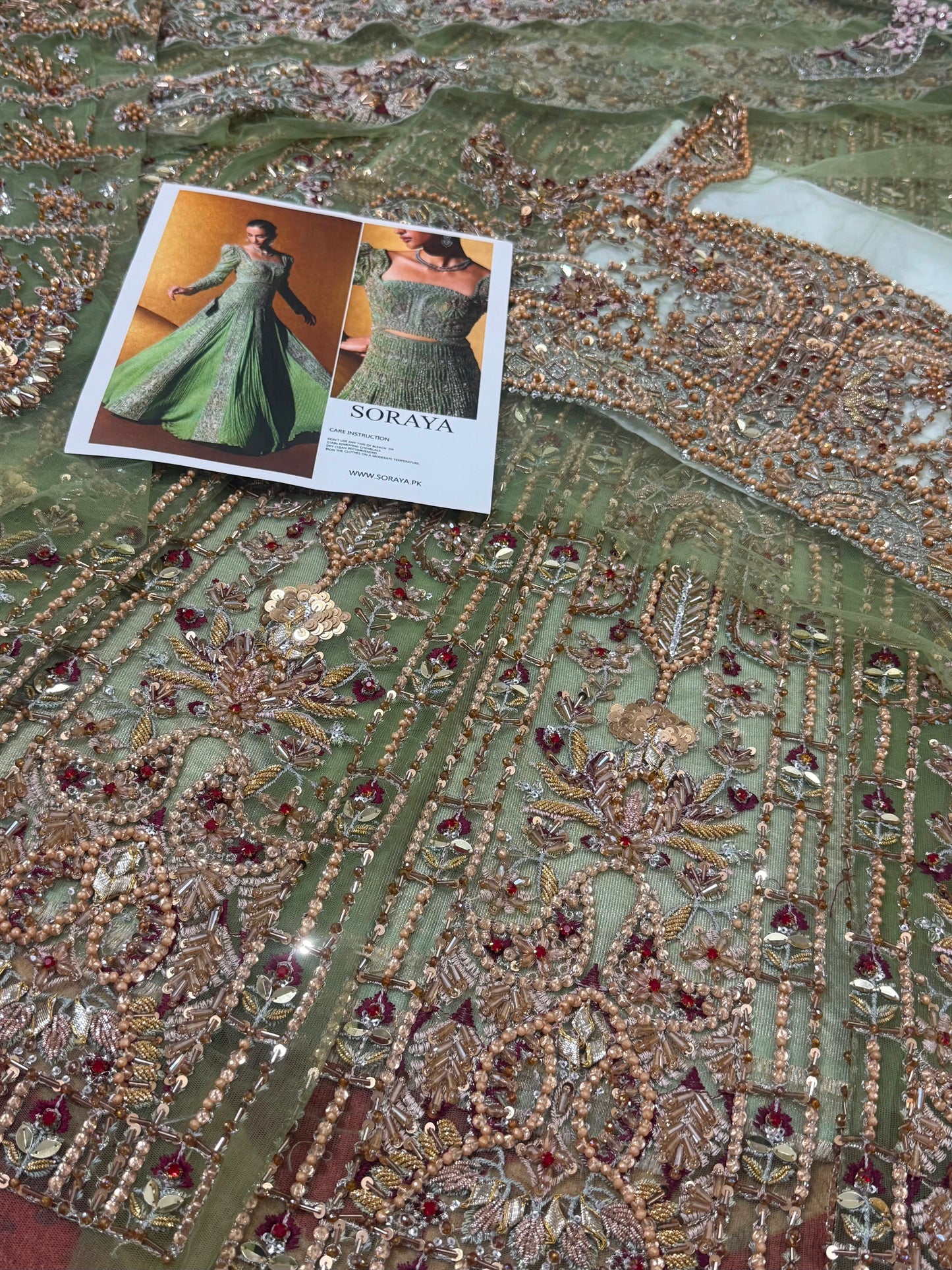 Close-up of Soraya Celvere Pakistani wedding partywear maxi featuring handcrafted embellishments, luxury crystal detailing, premium embroidery, and couture fabric craftsmanship.