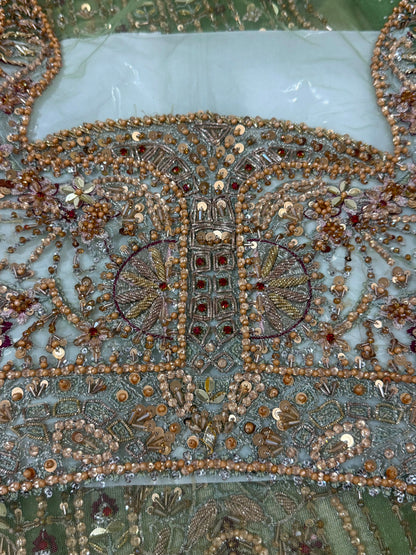 Soraya Celvere luxury Pakistani designer inspired maxi embroidery close-up featuring intricate hand embellishments, crystal stone work, premium couture craftsmanship, and elegant sage green wedding partywear fabric.